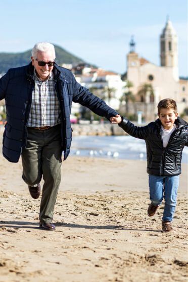 Grandpa and grandson during at the beach during our day trip to Tarragona and Sitges