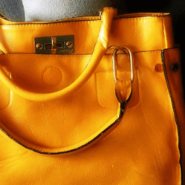 Branded yellow bag in La Roca Village