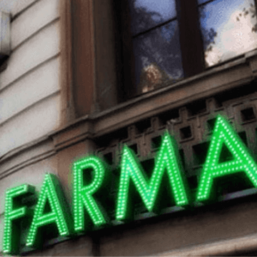 Green FARMA letters from a Barcelona pharmacy sign