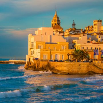 Sitges things to do: view of Old Sitges from Sant Sebastià beach