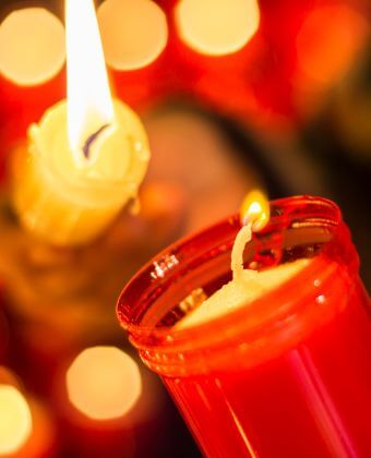 Red candle in Montserrat: spirituality is important in our Montserrat tours in Barcelona