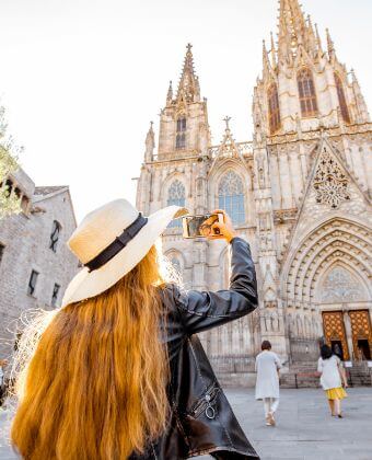 Lady taking a picture of the Cathedral during her half day tour in Barcelona