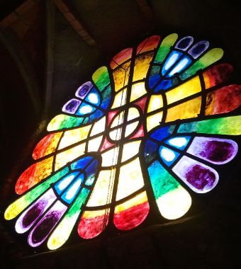 Stained glass in Colonia Guell, part of the best Gaudi tours in Barcelona Spain