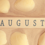 Word "August" written in a piece of wood in a beach in Barcelona
