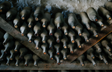 Rack of ancient dusted Spanish wine bottles